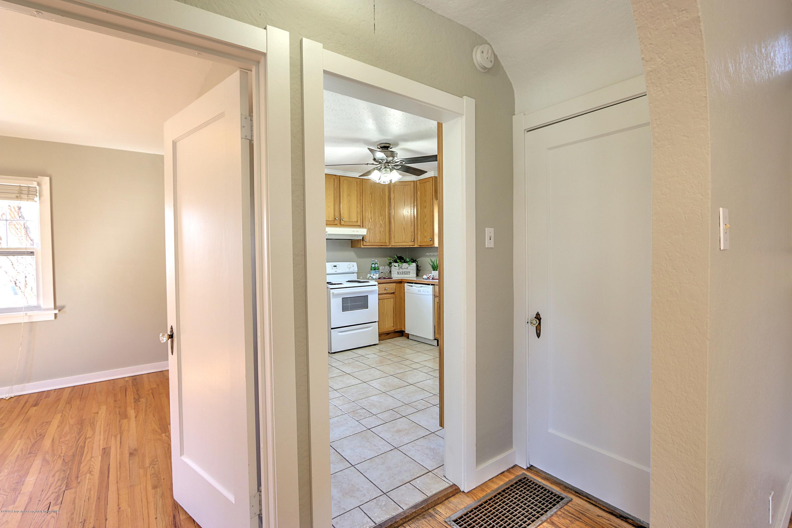 721 East Avenue Rifle, CO 81650 - Photo 8 of 24 a view of a hallway with wooden floor and a living room