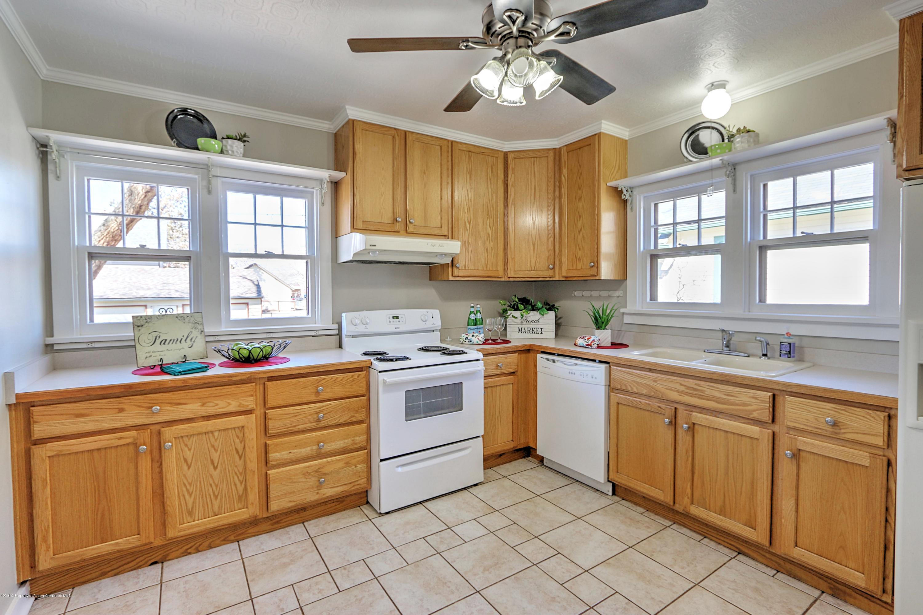 721 East Avenue Rifle, CO 81650 - Photo 9 of 24 a kitchen with a stove a sink and cabinets