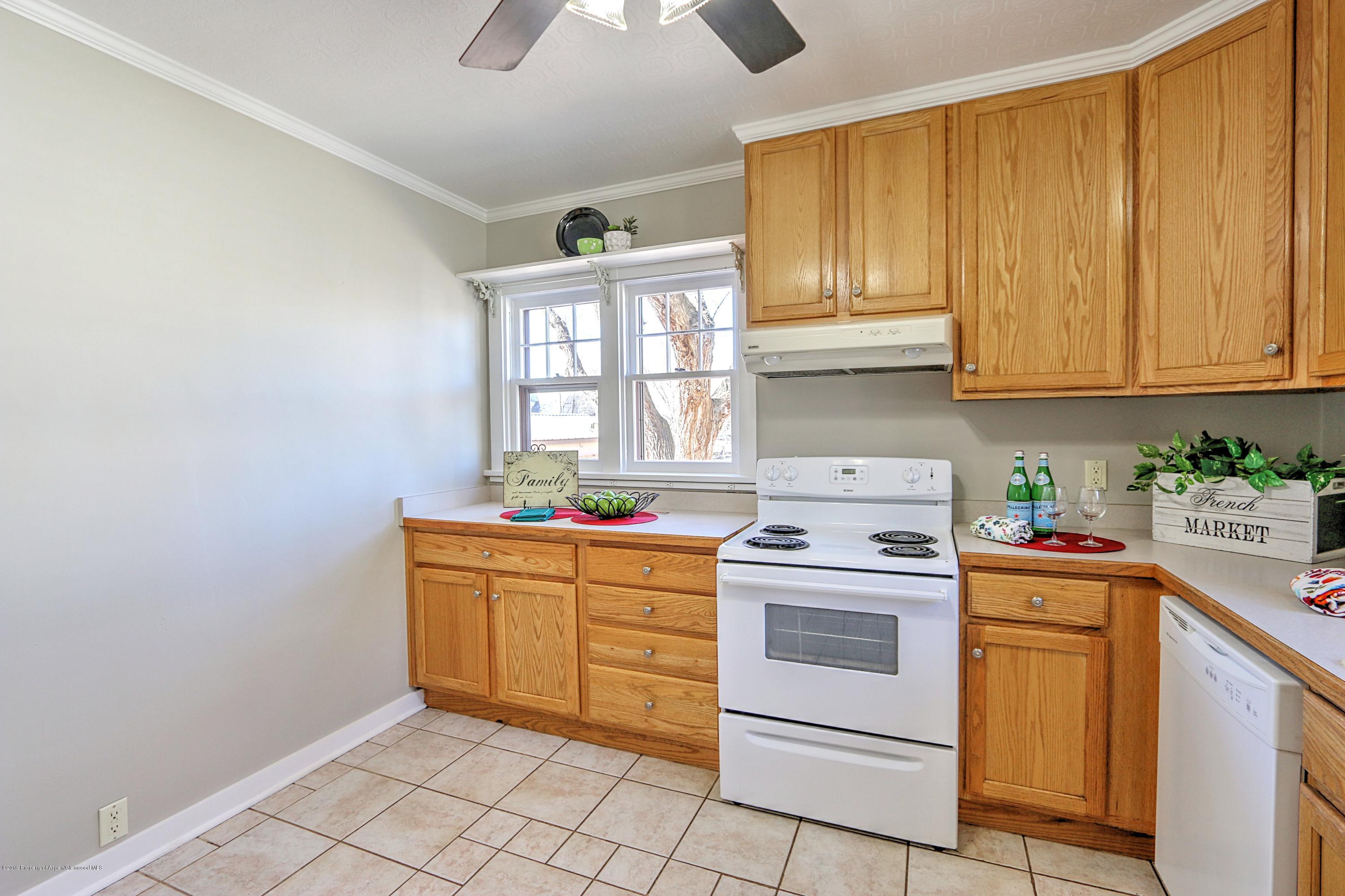 721 East Avenue Rifle, CO 81650 - Photo 10 of 24 a kitchen with cabinets appliances and a window