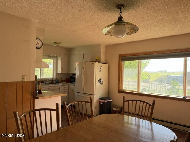61 Rivers Road Smith, NV 89430 - Photo 29 of 57 a kitchen with sink refrigerator dining table and chairs