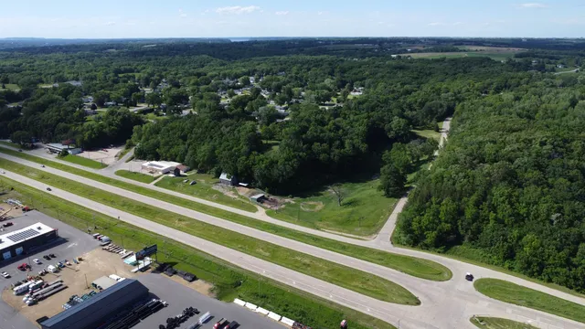 an aerial view of a houses with a yard