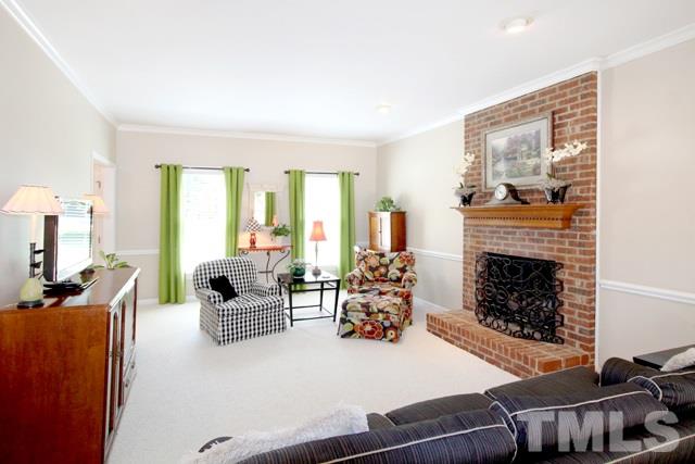 4440 Oak Park Road Raleigh, NC 27612 - Photo 9 of 25 Large family room features masonry fireplace and doors to the huge deck