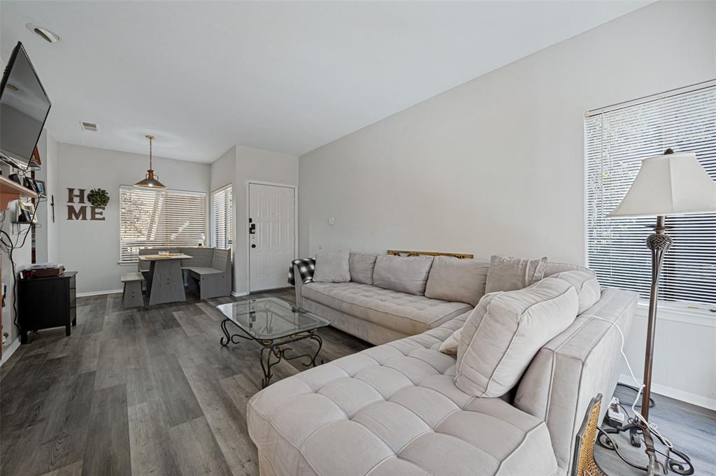 5550 Spring Valley Road, Unit C21 Dallas, TX 75254 - Photo 8 of 26 Wood-finish flooring throughout, with a built-in dining nook featuring bench seating