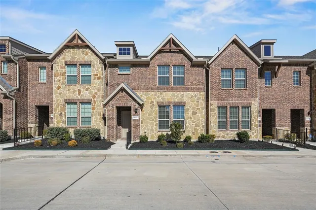 front view of a brick house with a street