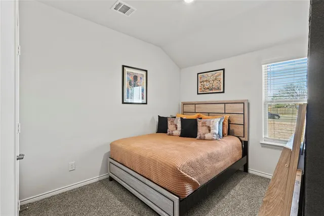 a bedroom with a bed and a wall painting