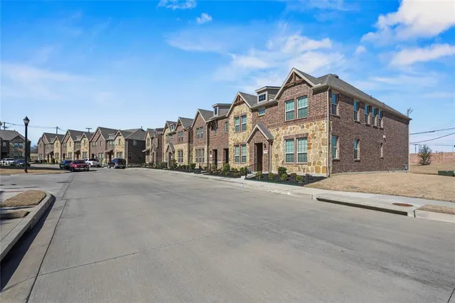 a view of multiple houses with a street