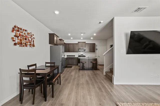 a kitchen with a sink a counter top space and stainless steel appliances