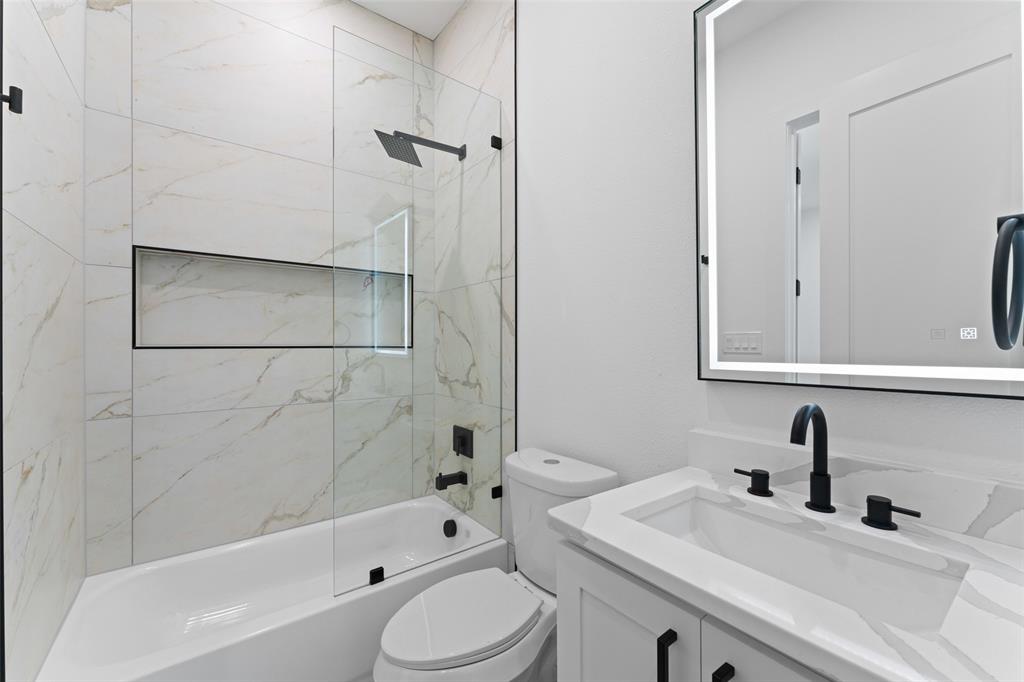 2826 Rochester Street Dallas, TX 75215 - Photo 23 of 38 Bathroom featuring vanity and bathing tub / shower combination