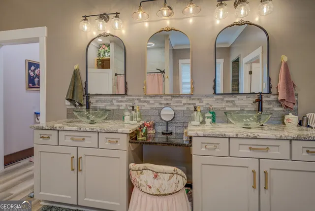 a view of staircase with lots of frames on wall and a window
