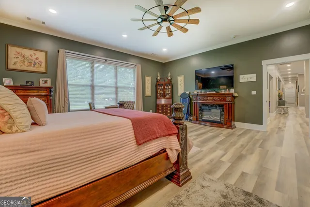 a living room with furniture and a view of kitchen