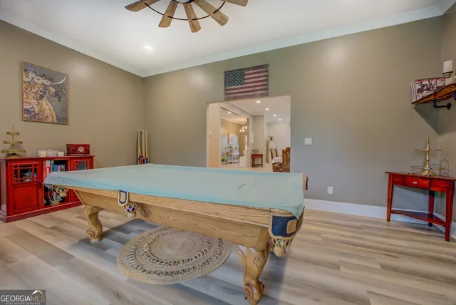 a spacious bedroom with a bed and a flat screen tv