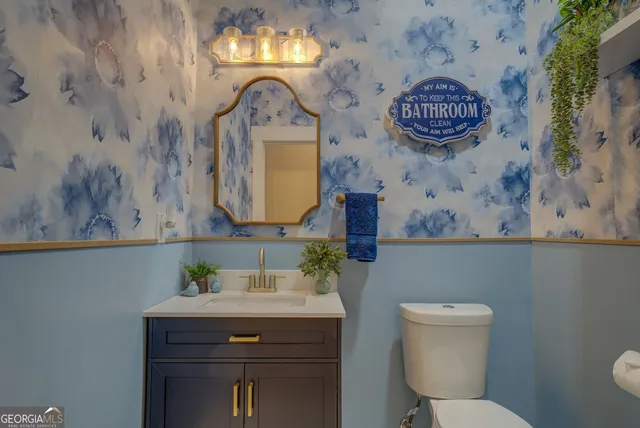 a bedroom with a bed wooden floor and a large window