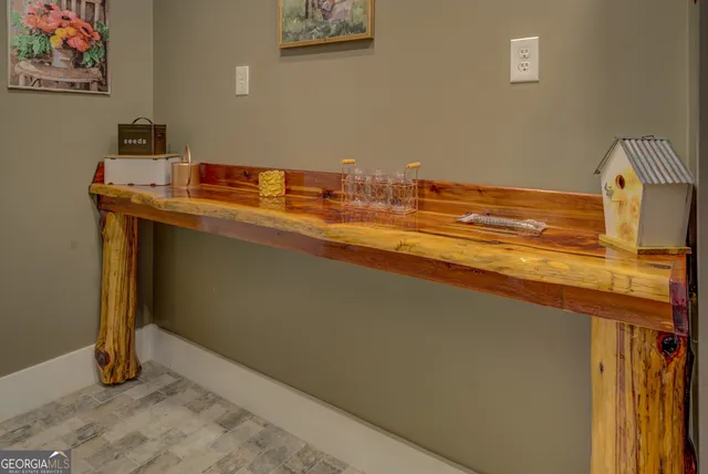 a backyard of a house with barbeque oven table and chairs
