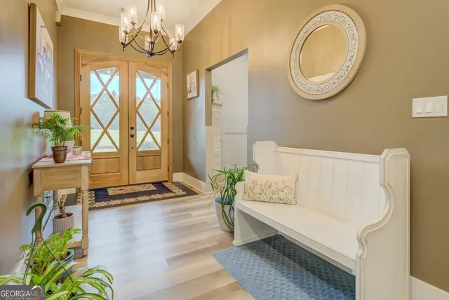 a dining room with furniture a chandelier and wooden floor