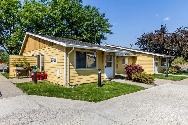 a front view of house with yard and green space