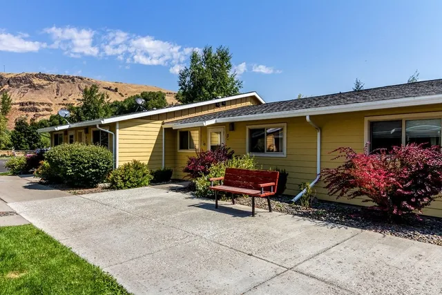 a view of a chairs and table in the back yard of the house