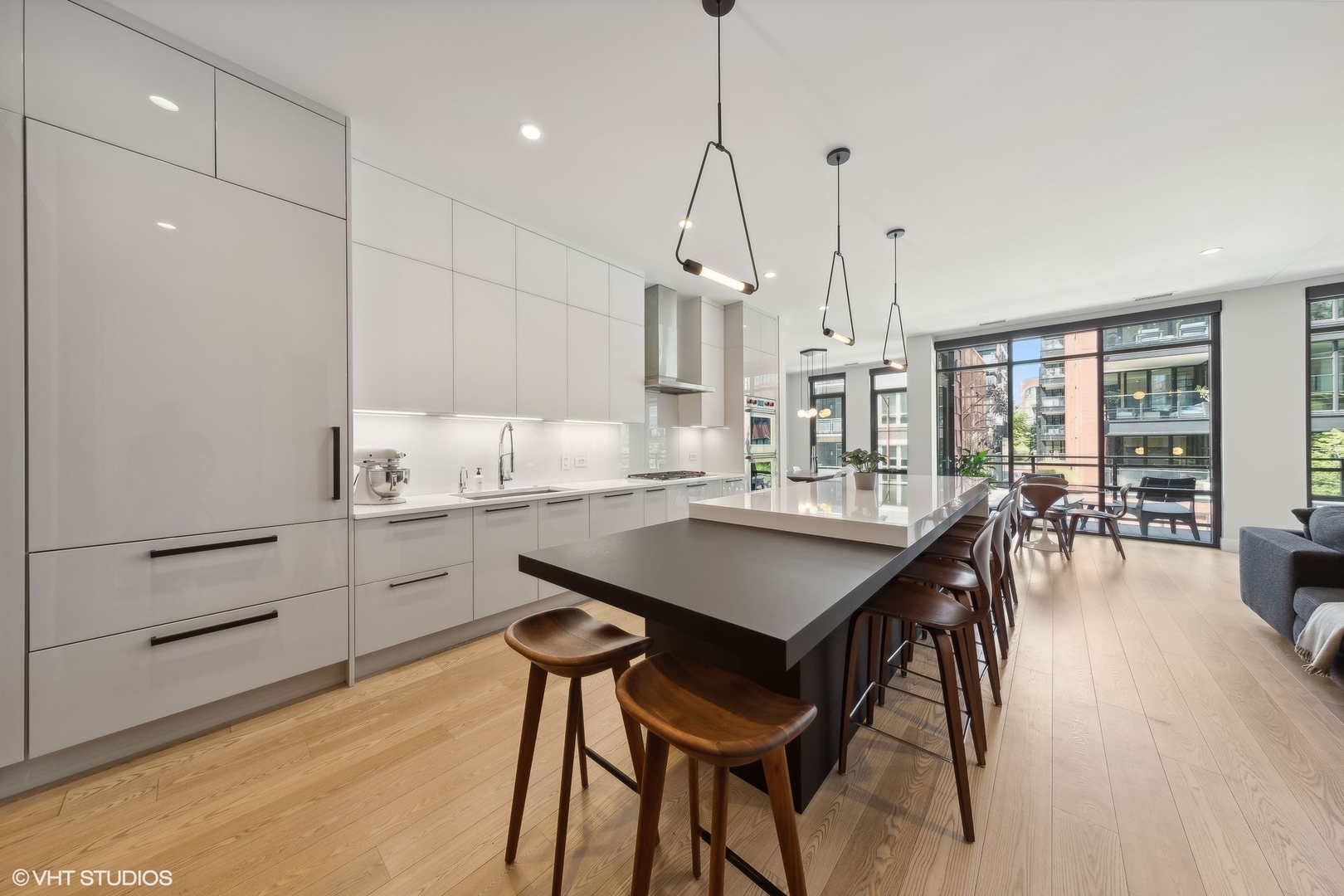 35 North Aberdeen Street, Unit 2S Chicago, IL 60607 - Photo 13 of 46 a kitchen with kitchen island a wooden floor and white appliances
