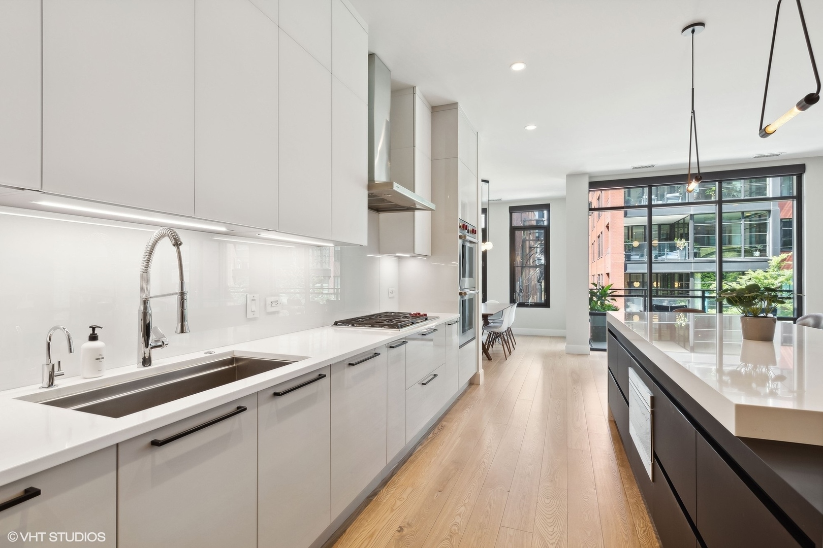 35 North Aberdeen Street, Unit 2S Chicago, IL 60607 - Photo 14 of 46 a large kitchen with kitchen island a sink stainless steel appliances and cabinets
