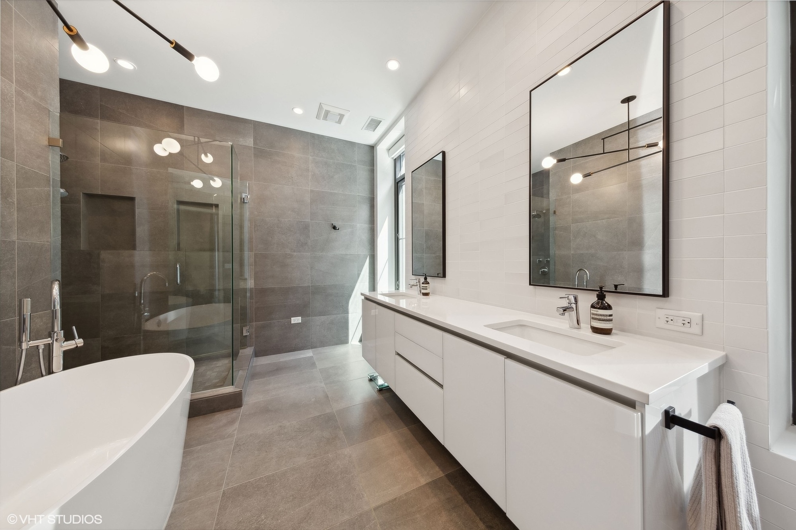 35 North Aberdeen Street, Unit 2S Chicago, IL 60607 - Photo 27 of 46 a bathroom with a double vanity sink a toilet a mirror and shower