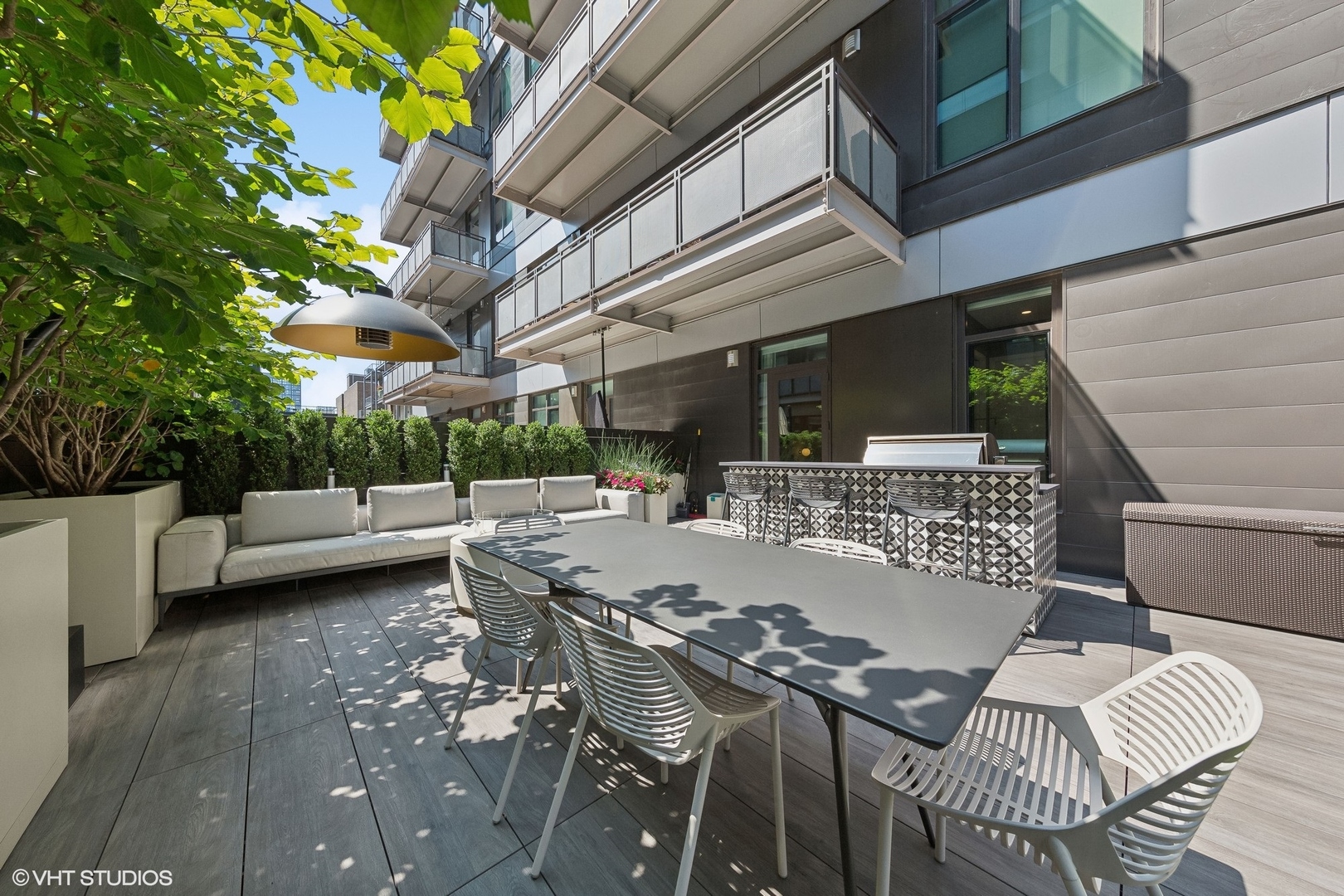 35 North Aberdeen Street, Unit 2S Chicago, IL 60607 - Photo 43 of 46 a view of a patio with couches table and chairs and potted plants