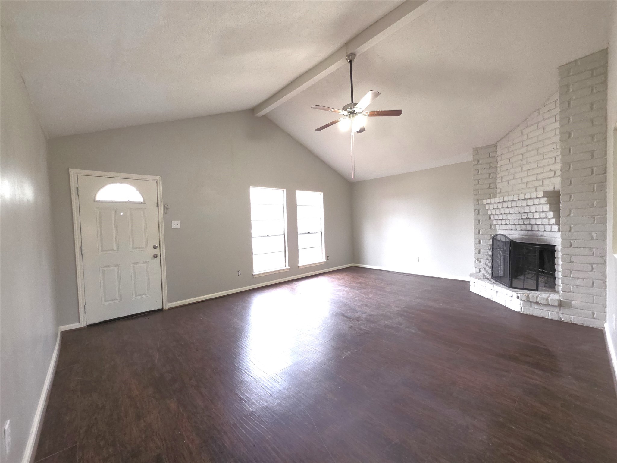 9814 Kiwi Lane Conroe, TX 77385 - Photo 4 of 13 an empty room with windows fireplace and wooden floor