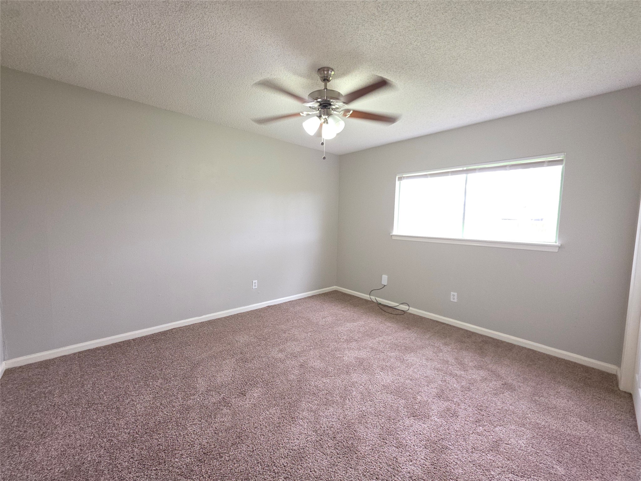 9814 Kiwi Lane Conroe, TX 77385 - Photo 8 of 13 an empty room with windows and fan