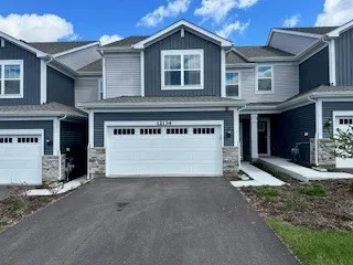 a view of a house with a yard and garage