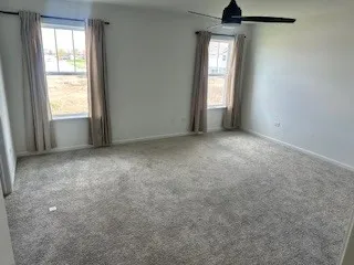 an empty room with windows and cabinet
