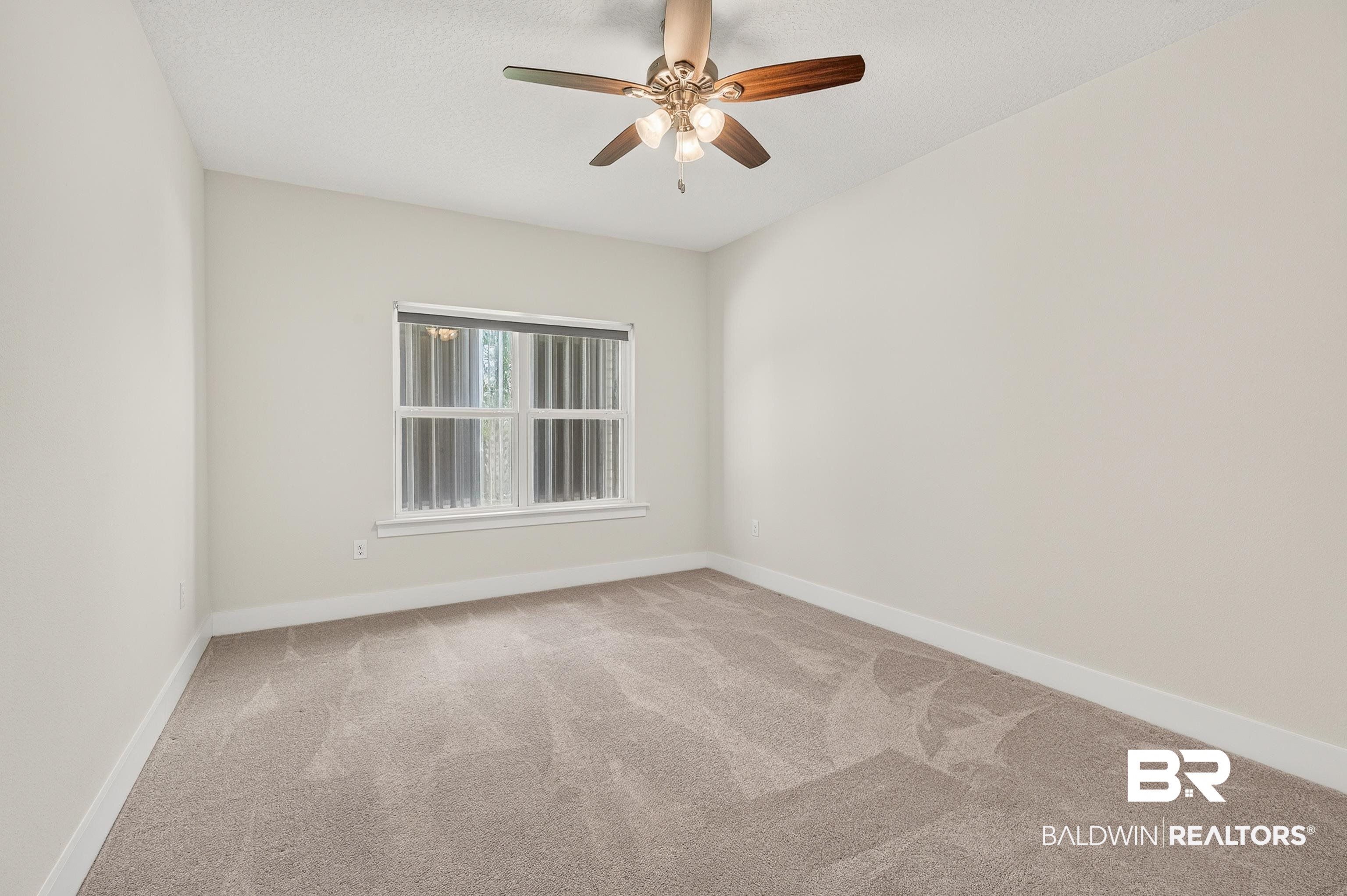 1724 Partridge Street Foley, AL 36535 - Photo 40 of 62 Neutral-toned room featuring a ceiling fan with integrated lighting, carpet flooring, a window with horizontal blinds, and white baseboards