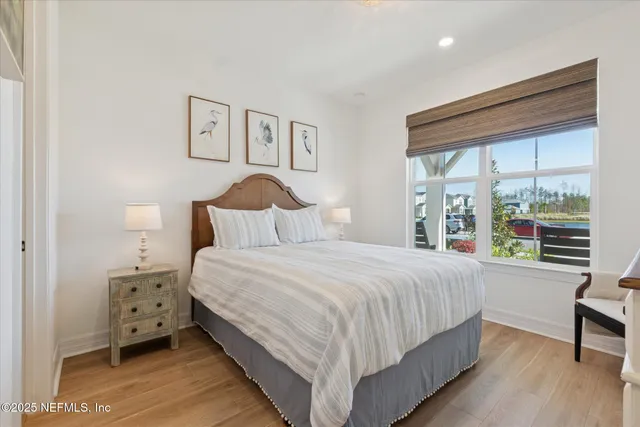 a bedroom with a bed and painting on the wall