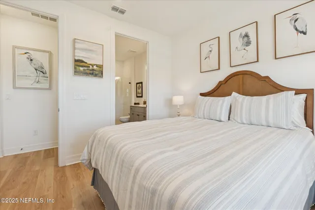 a bathroom with a toilet a sink a mirror and a window