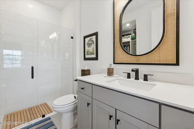 a room with a walk in closet and a mirror