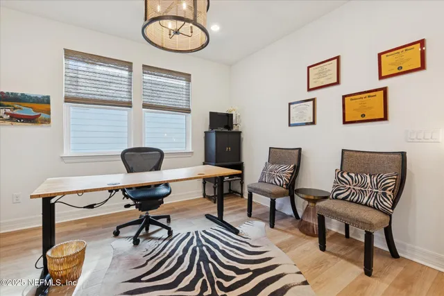 a living room with furniture a flat screen tv and a rug