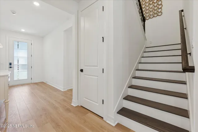 a bedroom with bed and a large window