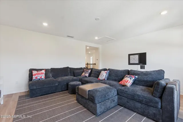 a bathroom with a granite countertop sink a toilet and a shower curtain