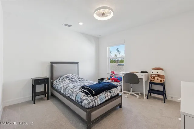 a bedroom with a bed and a table in it