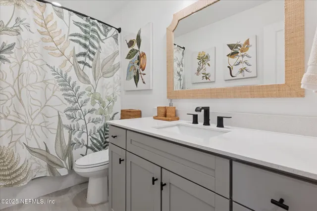 a bedroom with a bed and flat screen tv