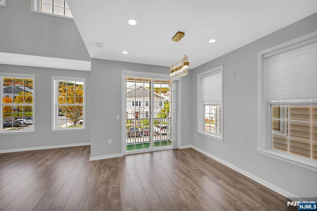41 Sequoia Drive Cedar Grove, NJ 07009 - Photo 13 of 49 an empty room with wooden floor and windows