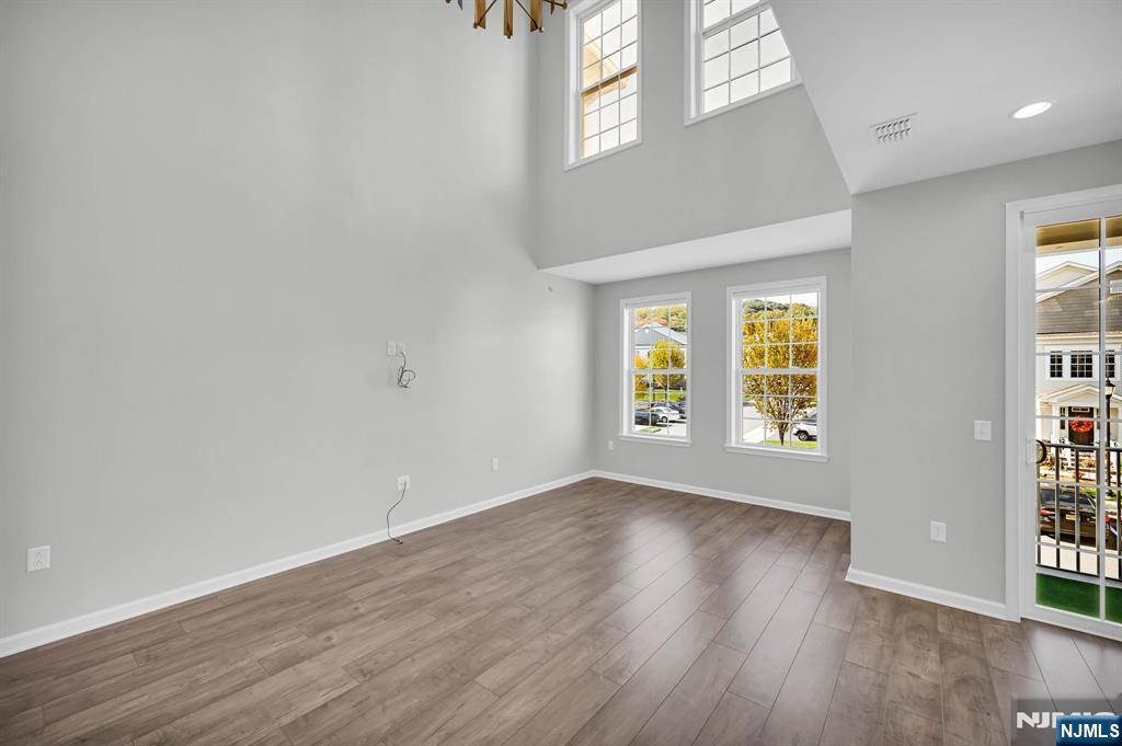 41 Sequoia Drive Cedar Grove, NJ 07009 - Photo 15 of 49 an empty room with wooden floor and windows