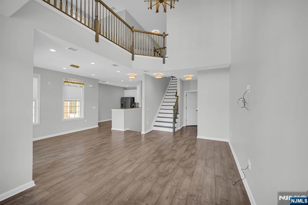 41 Sequoia Drive Cedar Grove, NJ 07009 - Photo 2 of 49 a view of an empty room with wooden floor and a window