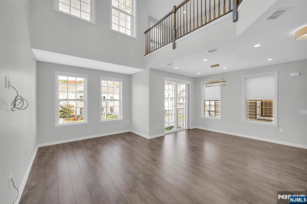 41 Sequoia Drive Cedar Grove, NJ 07009 - Photo 4 of 49 a view of an empty room with wooden floor and a window