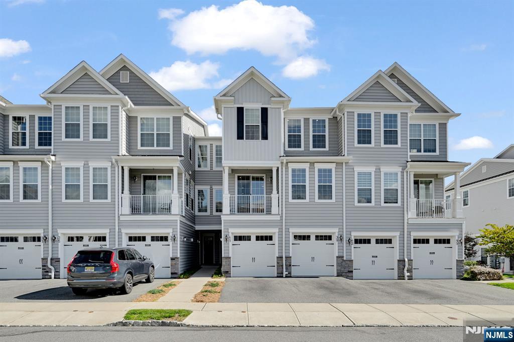 41 Sequoia Drive Cedar Grove, NJ 07009 - Photo 5 of 49 a front view of a building with lot of cars and trees
