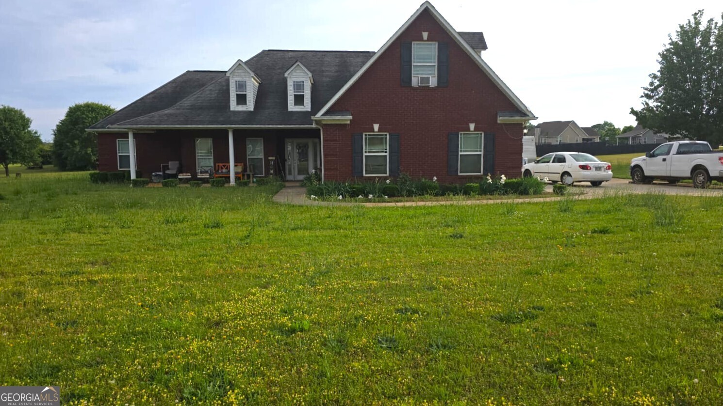 a front view of a house with a garden
