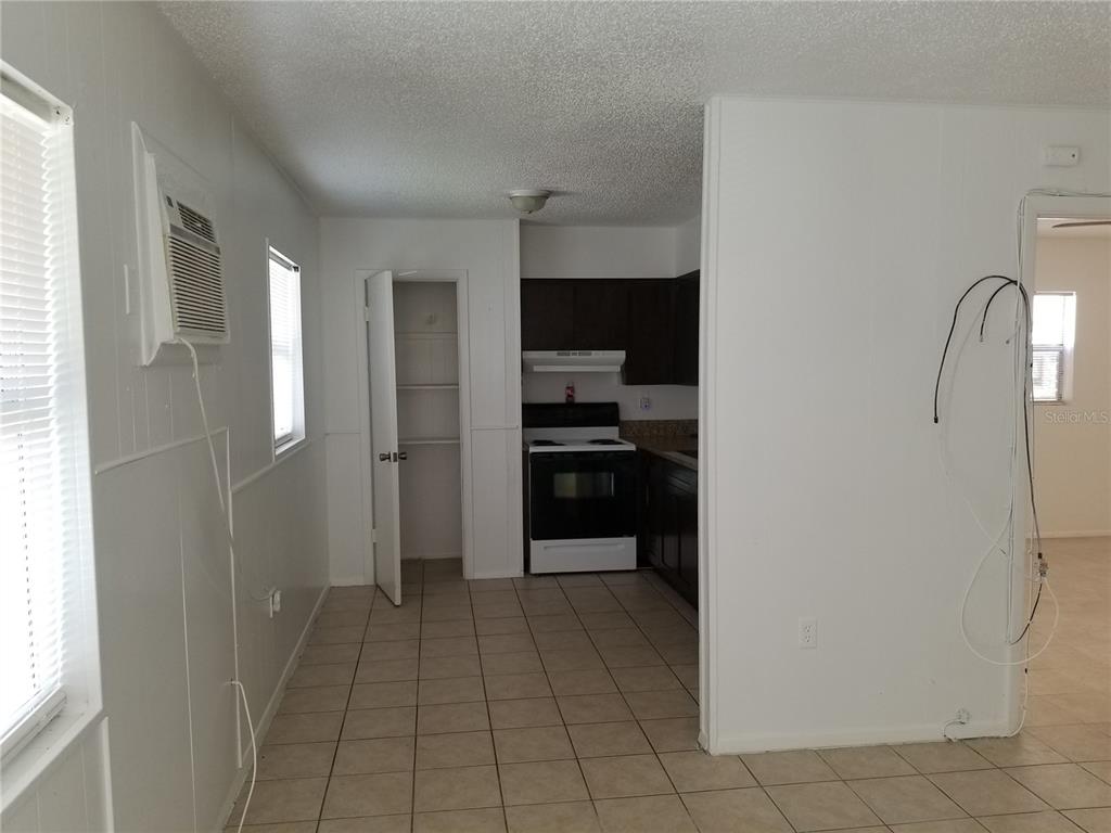 1306 East 137th Avenue, Unit B Tampa, FL 33613 - Photo 2 of 10 a view of a kitchen from the hallway