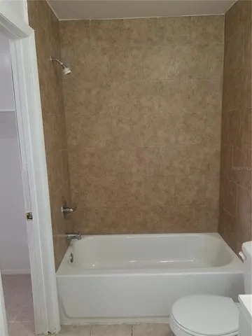 a bathroom with a toilet and bathtub
