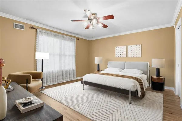 a bedroom with a bed and wooden floor