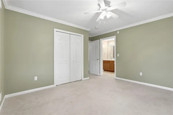 an empty room with a ceiling fan and a window