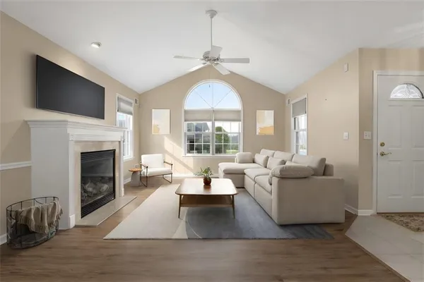 a living room with furniture a fireplace and a flat screen tv