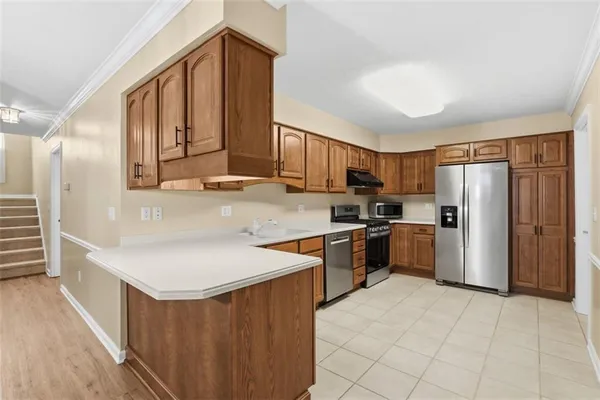 a kitchen with stainless steel appliances granite countertop a refrigerator sink and cabinets