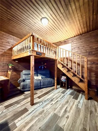 a view of a hallway with wooden floor and stairs